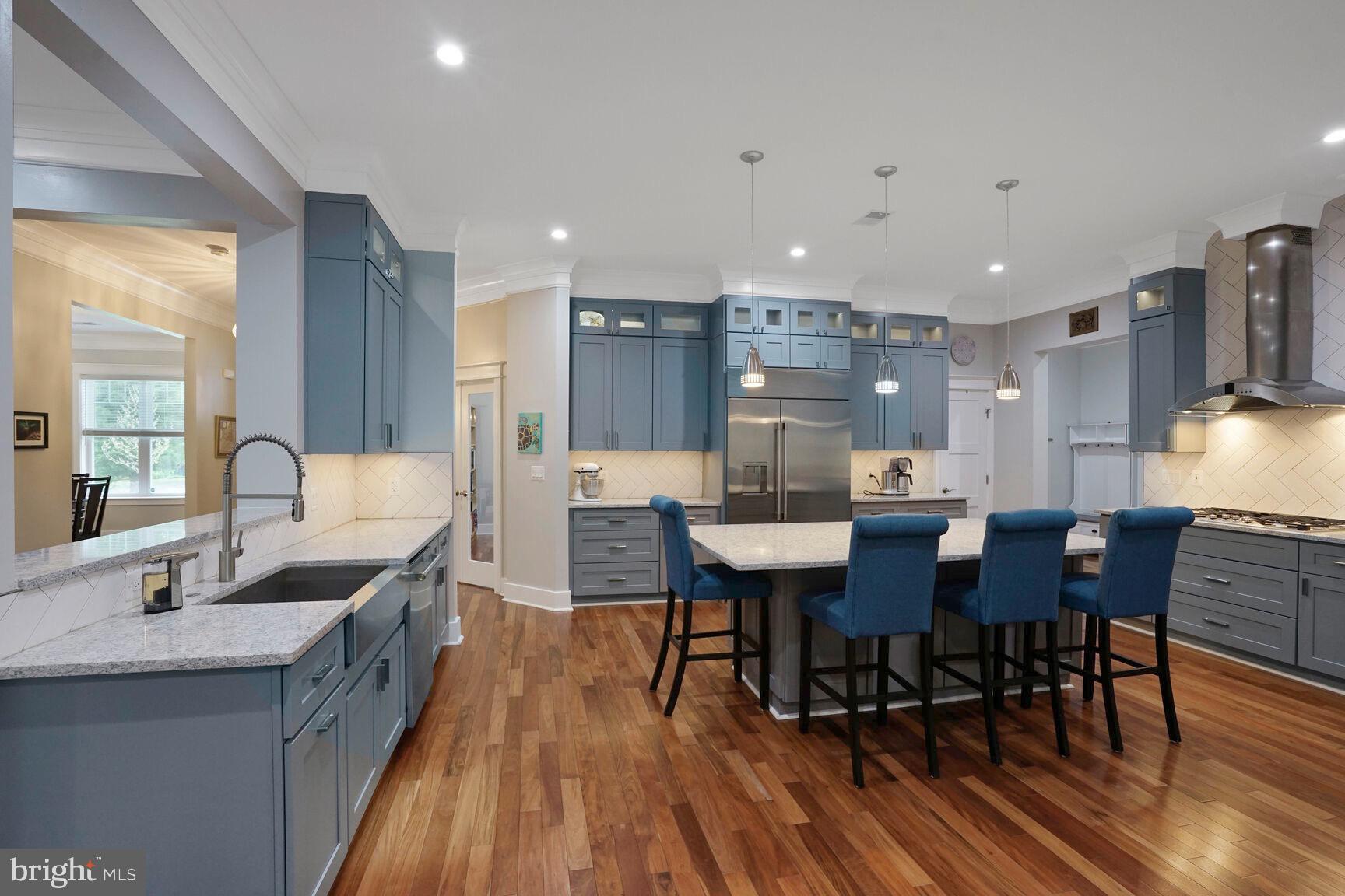 7045 Barbara Road Alexandria, VA 22315 - Photo 11 of 57 a kitchen with stainless steel appliances kitchen island granite countertop a sink a stove a dining table and chairs