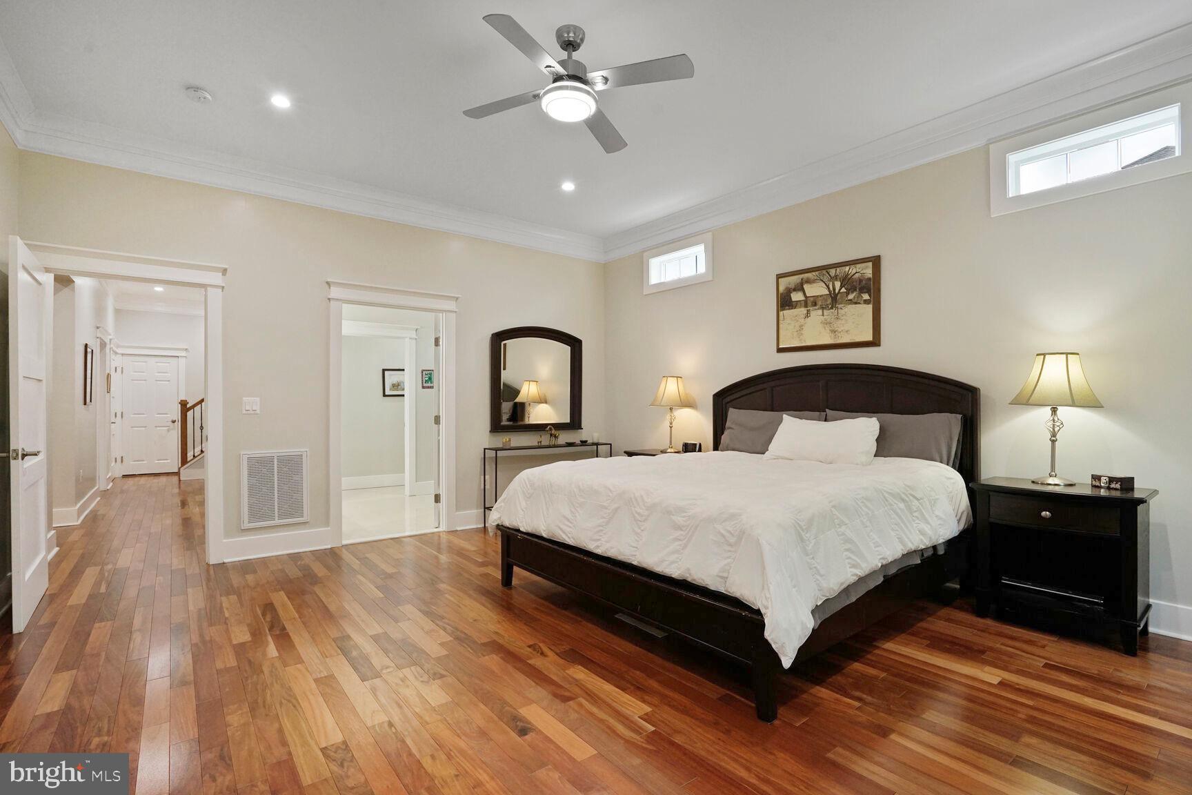 7045 Barbara Road Alexandria, VA 22315 - Photo 20 of 57 a bedroom with a bed and a chandelier