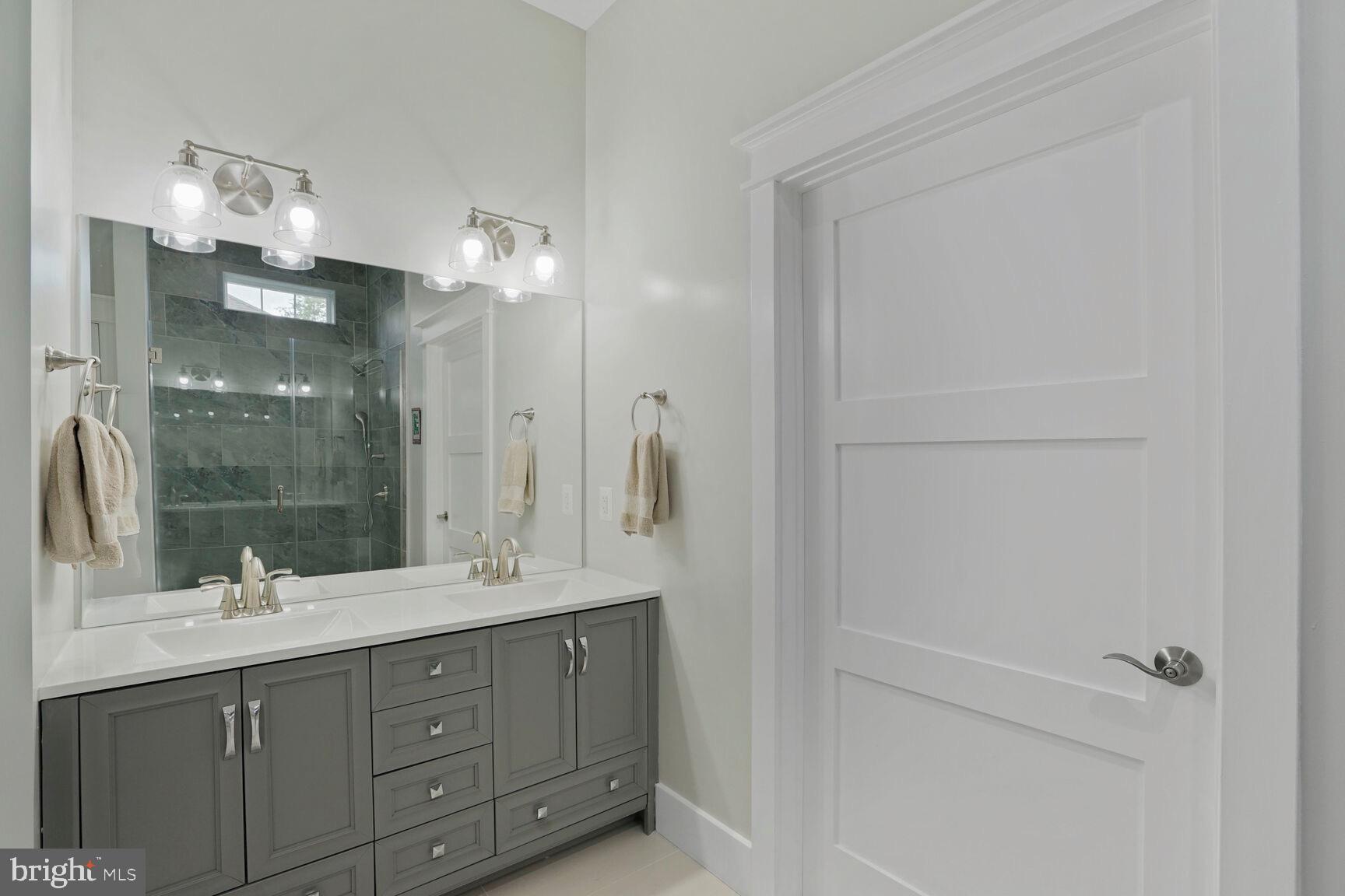 7045 Barbara Road Alexandria, VA 22315 - Photo 21 of 57 a bathroom with a double vanity sink mirror and double