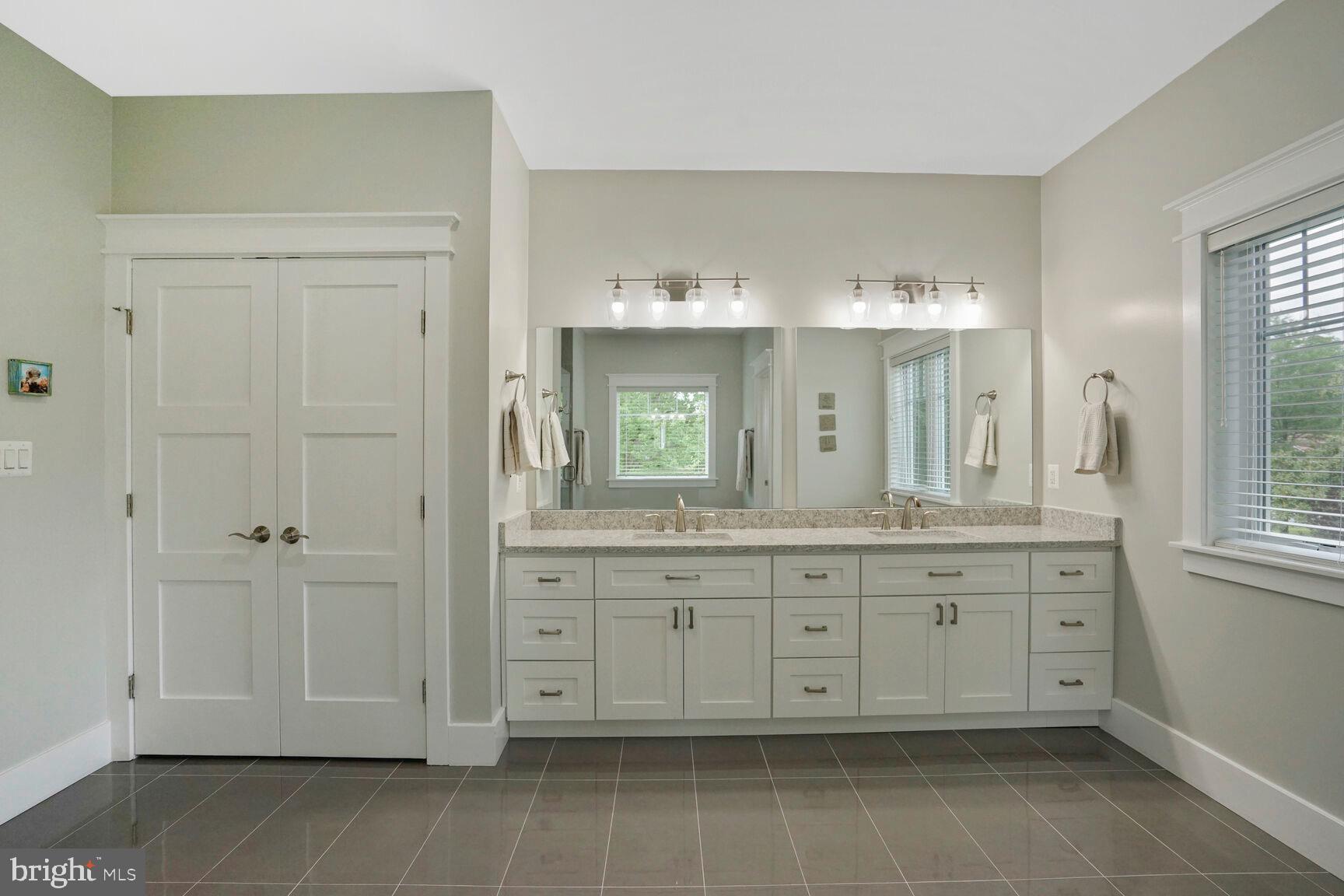 7045 Barbara Road Alexandria, VA 22315 - Photo 33 of 57 a bathroom with a granite countertop double vanity sink and mirror