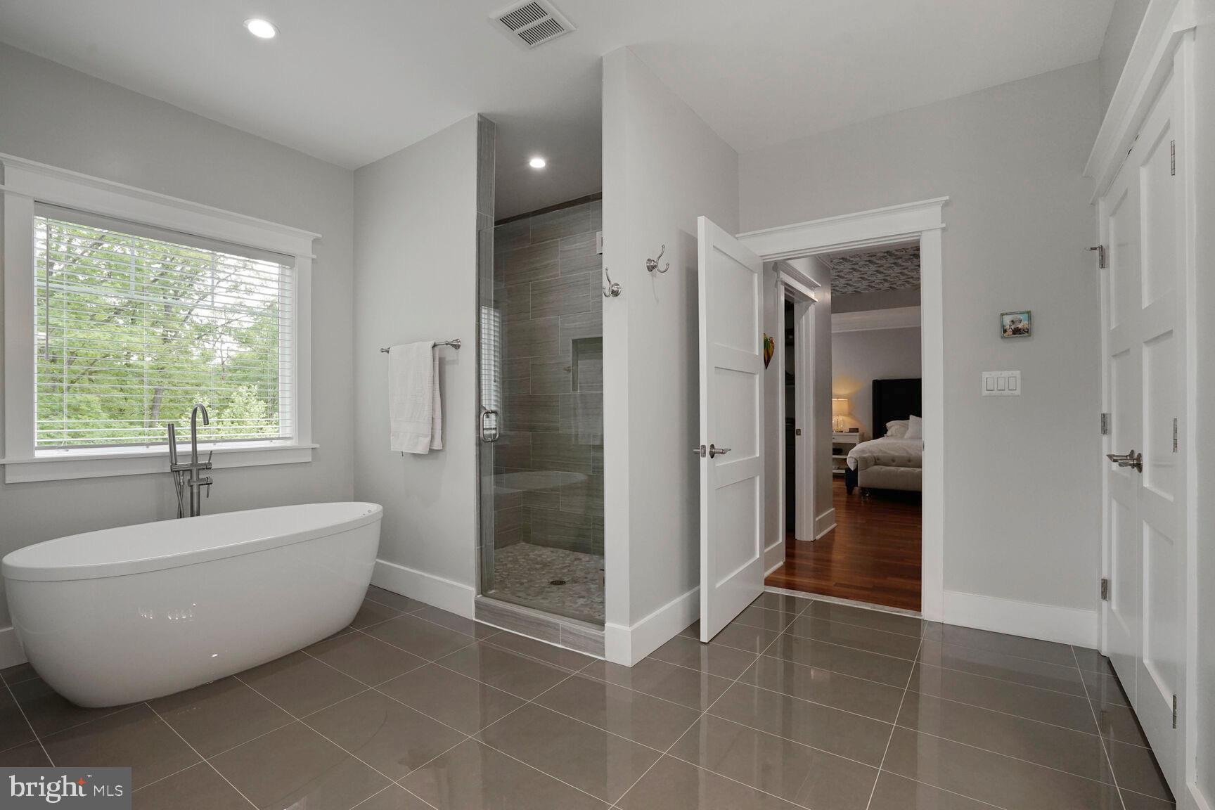 7045 Barbara Road Alexandria, VA 22315 - Photo 34 of 57 a spacious bathroom with a bathtub and shower