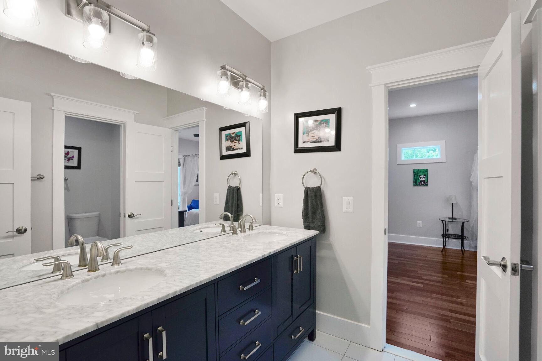 7045 Barbara Road Alexandria, VA 22315 - Photo 42 of 57 a bathroom with a granite countertop double vanity sink and a mirror