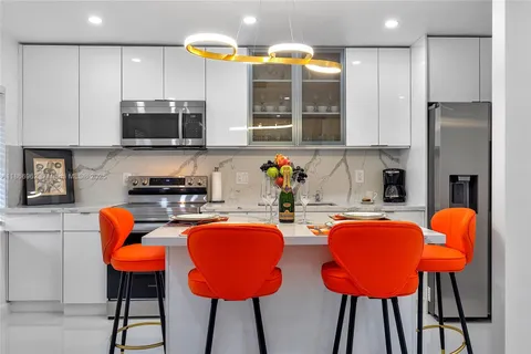 a living room with furniture a dining table and chairs