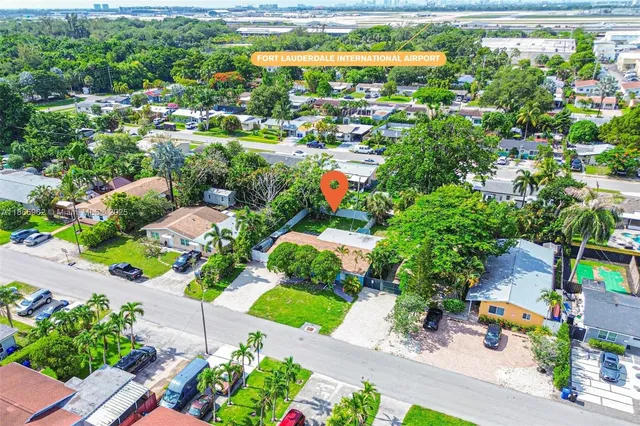 an aerial view of residential houses with outdoor space and street view