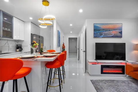 a kitchen with stainless steel appliances granite countertop a sink and a refrigerator