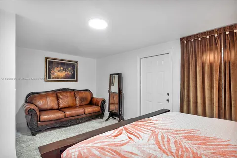 a kitchen with stainless steel appliances kitchen island granite countertop a table and chairs in it