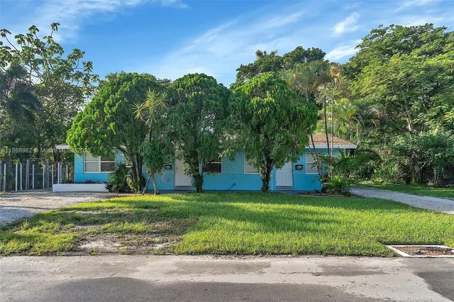 a kitchen with stainless steel appliances kitchen island granite countertop a table chairs sink and cabinets