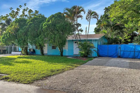 a kitchen with stainless steel appliances granite countertop a sink a stove a refrigerator a microwave with a dining table and chairs