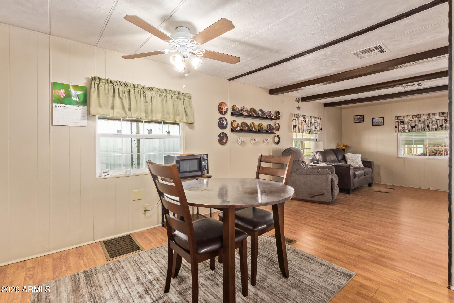 201 South Greenfield Road, Unit 291 Mesa, AZ 85206 - Photo 12 of 34 a view of a dining room with furniture window and wooden floor