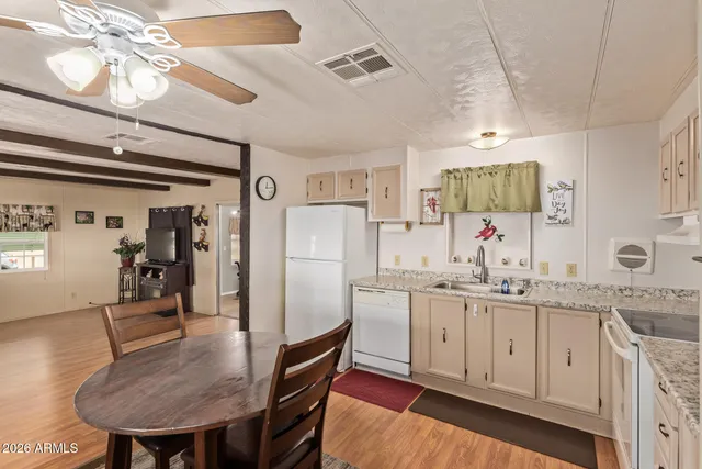 a kitchen with granite countertop cabinets and white appliances