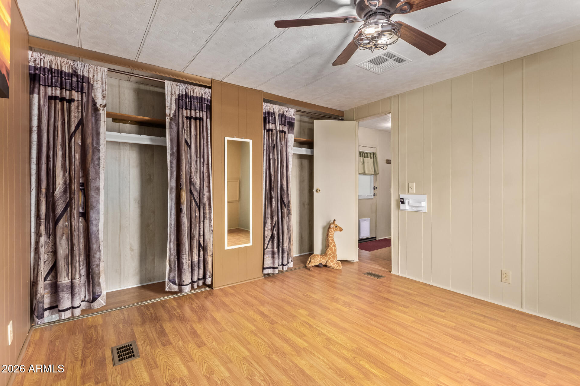 201 South Greenfield Road, Unit 291 Mesa, AZ 85206 - Photo 18 of 34 a view of empty room with wooden floor and fan