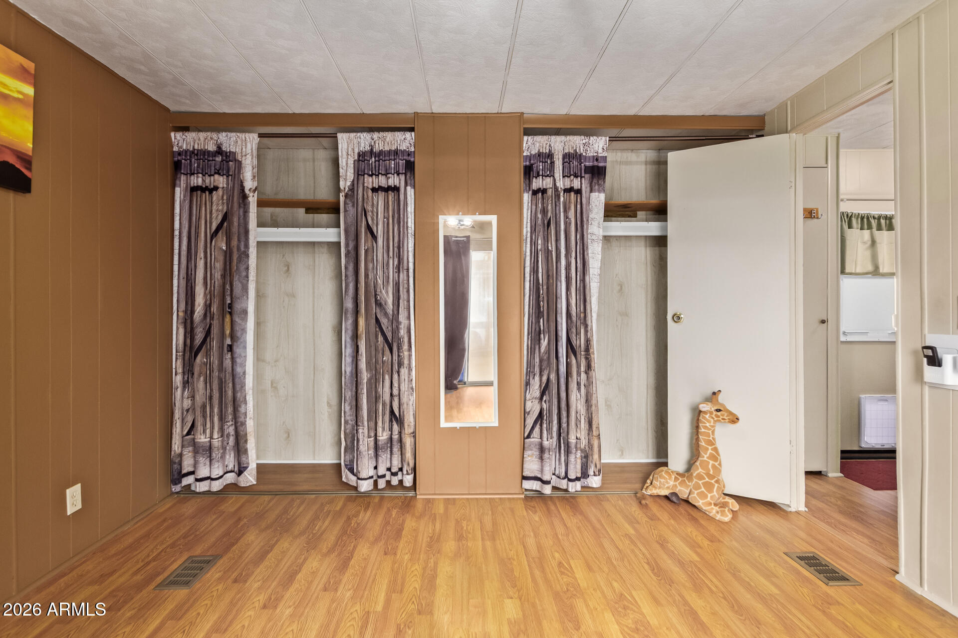 201 South Greenfield Road, Unit 291 Mesa, AZ 85206 - Photo 20 of 34 an empty room with wooden floor and windows