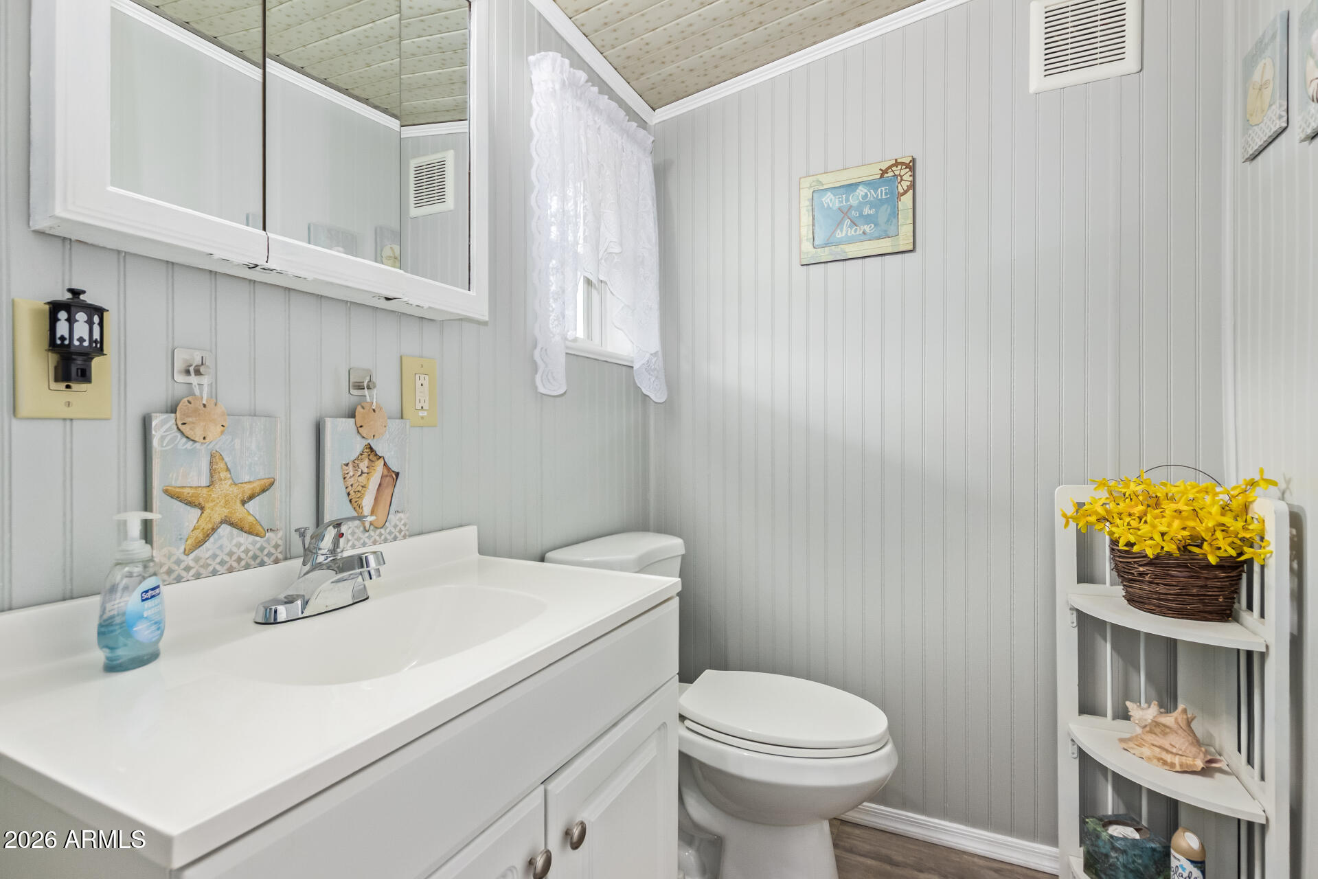 201 South Greenfield Road, Unit 291 Mesa, AZ 85206 - Photo 26 of 34 a bathroom with a sink a toilet and a mirror