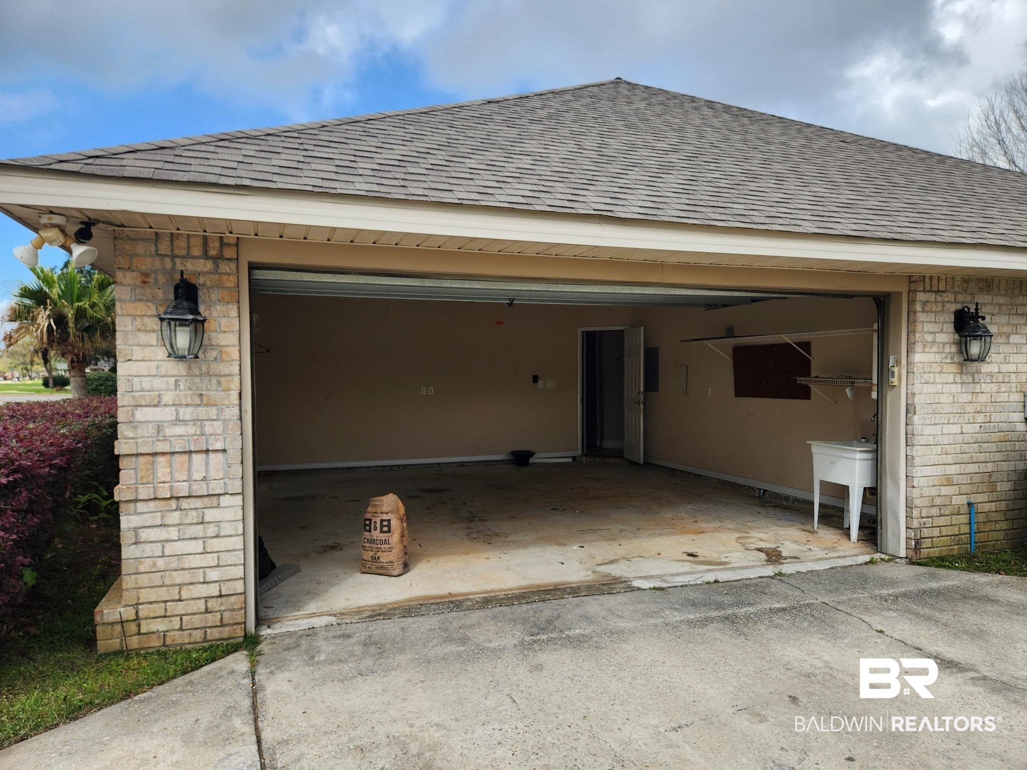 9425 Autauga Bend Daphne, AL 36526 - Photo 3 of 15 Garage with concrete driveway and a sink