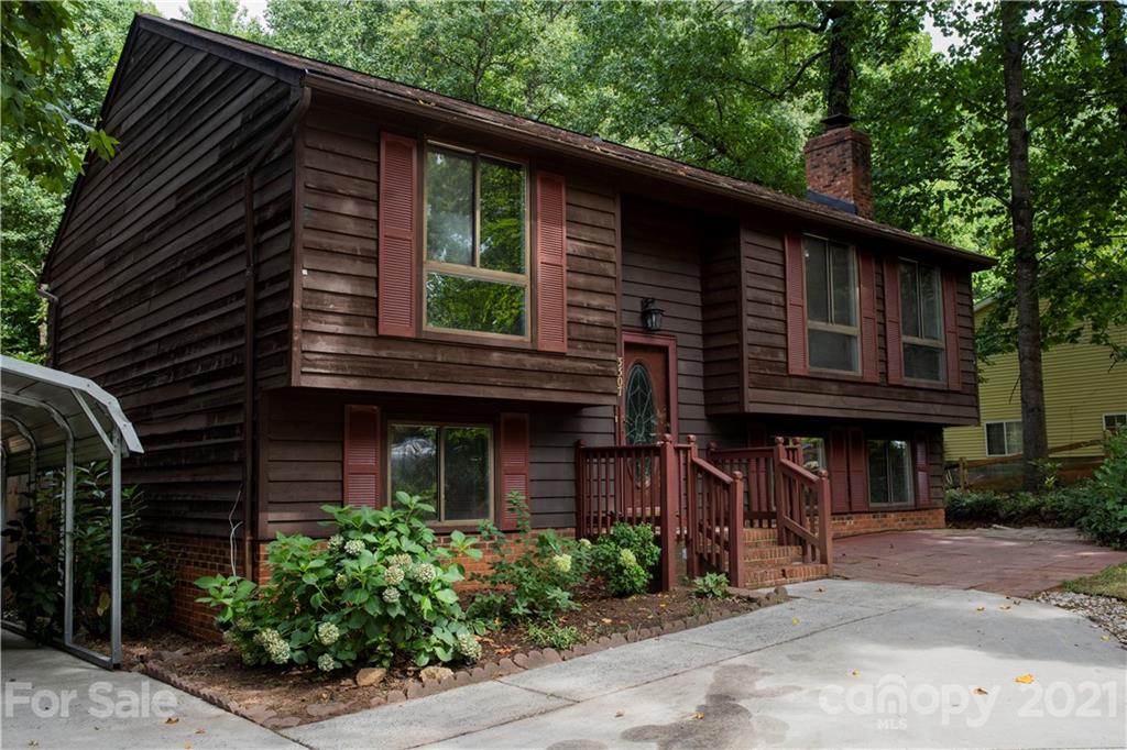a red brick house with trees in front of it