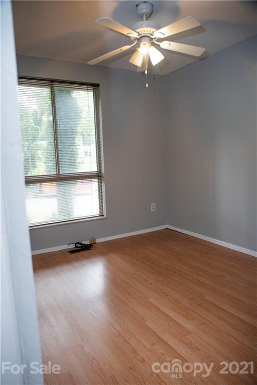 3307 Piney Grove Road Charlotte, NC 28212 - Photo 16 of 48 an empty room with wooden floor and windows