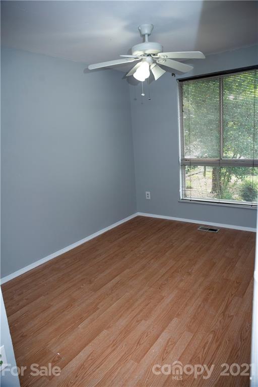 3307 Piney Grove Road Charlotte, NC 28212 - Photo 17 of 48 an empty room with wooden floor and windows