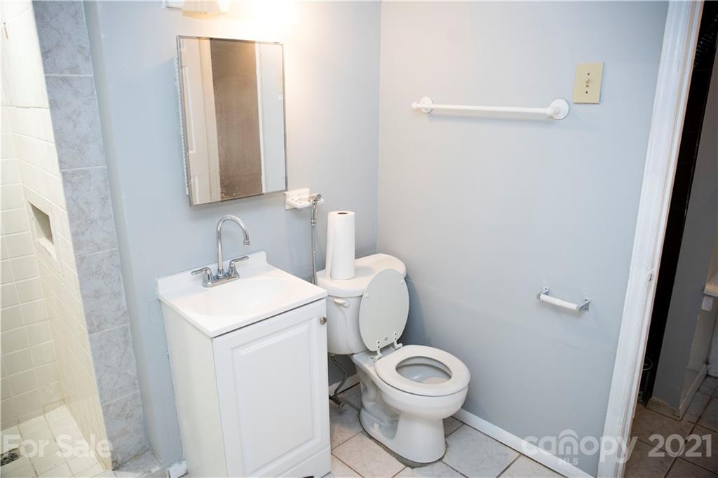 3307 Piney Grove Road Charlotte, NC 28212 - Photo 32 of 48 a bathroom with a toilet sink and mirror