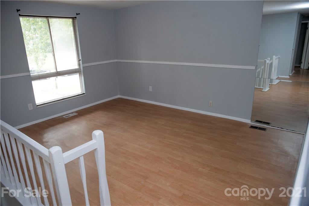 3307 Piney Grove Road Charlotte, NC 28212 - Photo 7 of 48 an empty room with wooden floor and windows