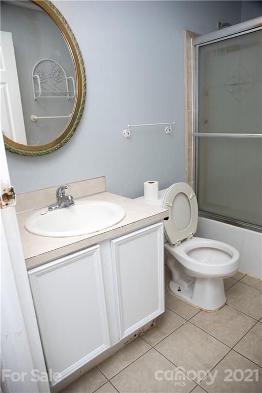 3307 Piney Grove Road Charlotte, NC 28212 - Photo 9 of 48 a white toilet sitting next to a bathroom sink