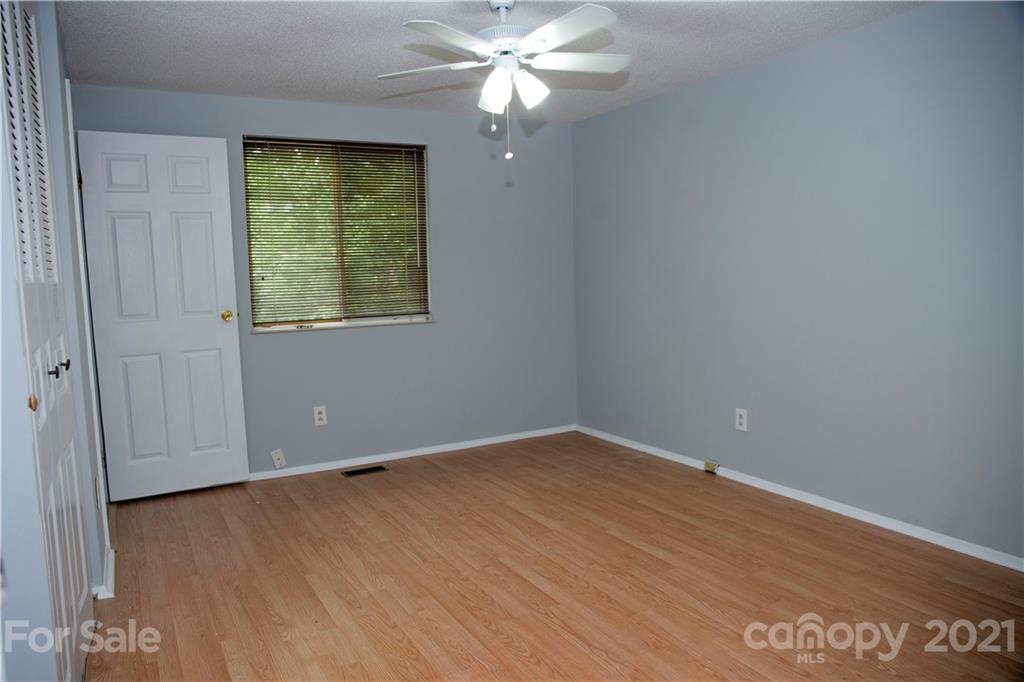3307 Piney Grove Road Charlotte, NC 28212 - Photo 10 of 48 an empty room with wooden floor closet and fan
