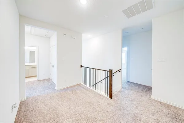 an empty room with a window and a ceiling fan