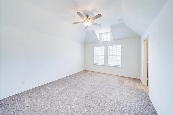 a view of a room with a ceiling fan and a window