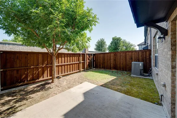 a view of a backyard with a small cabin and wooden fence