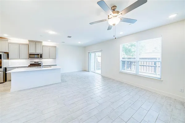 a kitchen with a sink a stove and cabinets
