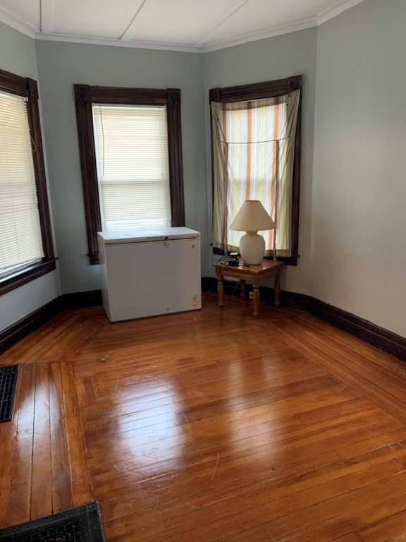 90 Fairfield Street Springfield, MA 01108 - Photo 5 of 9 a room with wooden floor and a window