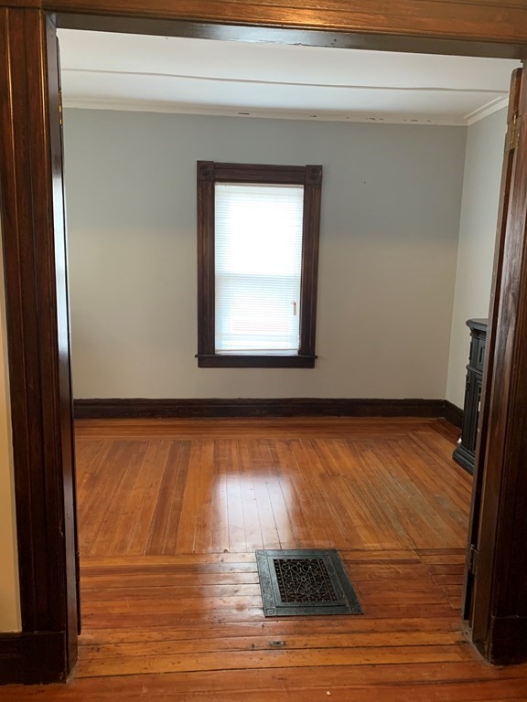 90 Fairfield Street Springfield, MA 01108 - Photo 6 of 9 a view of an empty room with wooden floor and a window