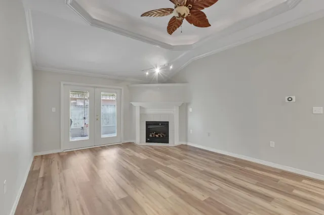 a view of empty room with wooden floor