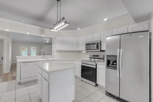a view of an empty room with a fireplace and a window