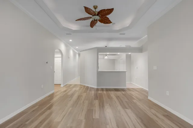 a view of a room with a wooden floor and ceiling fan