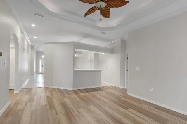 a bathroom with a toilet a sink a light fixture and a mirror