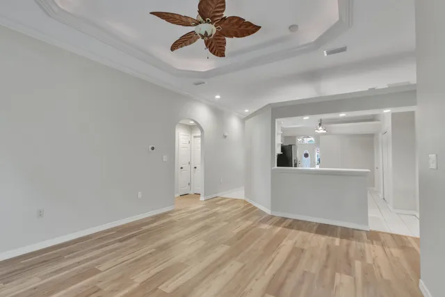 a view of a livingroom with a chandelier fan and entryway