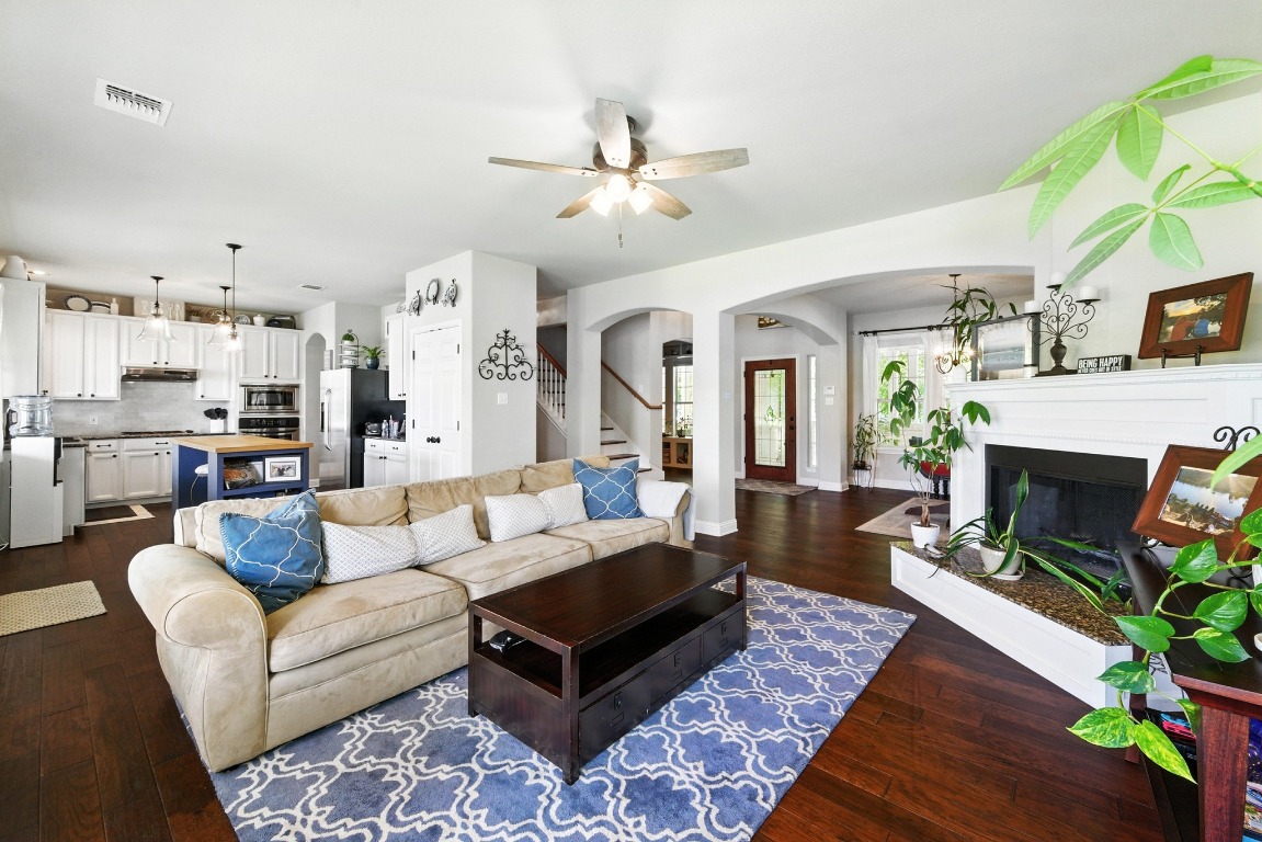 316 Caraway Kyle, TX 78640 - Photo 11 of 39 Living area featuring arched walkways, ceiling fan, wood flooring