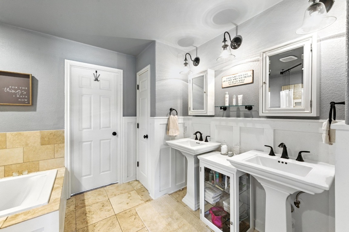 316 Caraway Kyle, TX 78640 - Photo 21 of 39 Full bath featuring a large soaking tub and a wainscoted wall