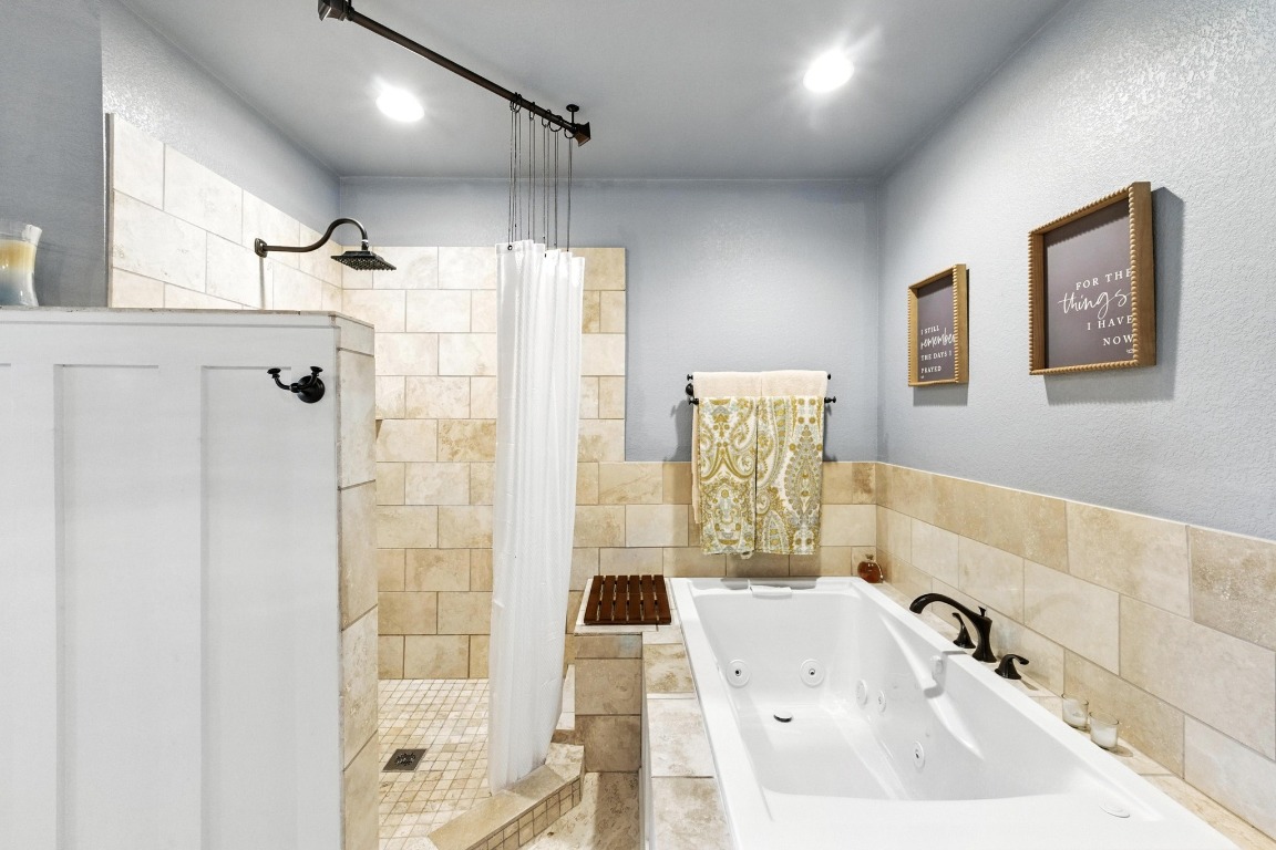 316 Caraway Kyle, TX 78640 - Photo 22 of 39 Full bathroom featuring a stall shower and a whirlpool tub