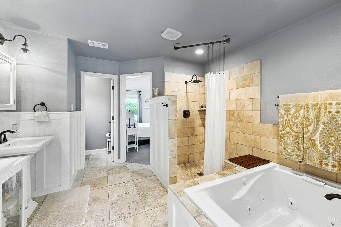 316 Caraway Kyle, TX 78640 - Photo 23 of 39 Bathroom featuring a walk in tile shower and a whirlpool tub