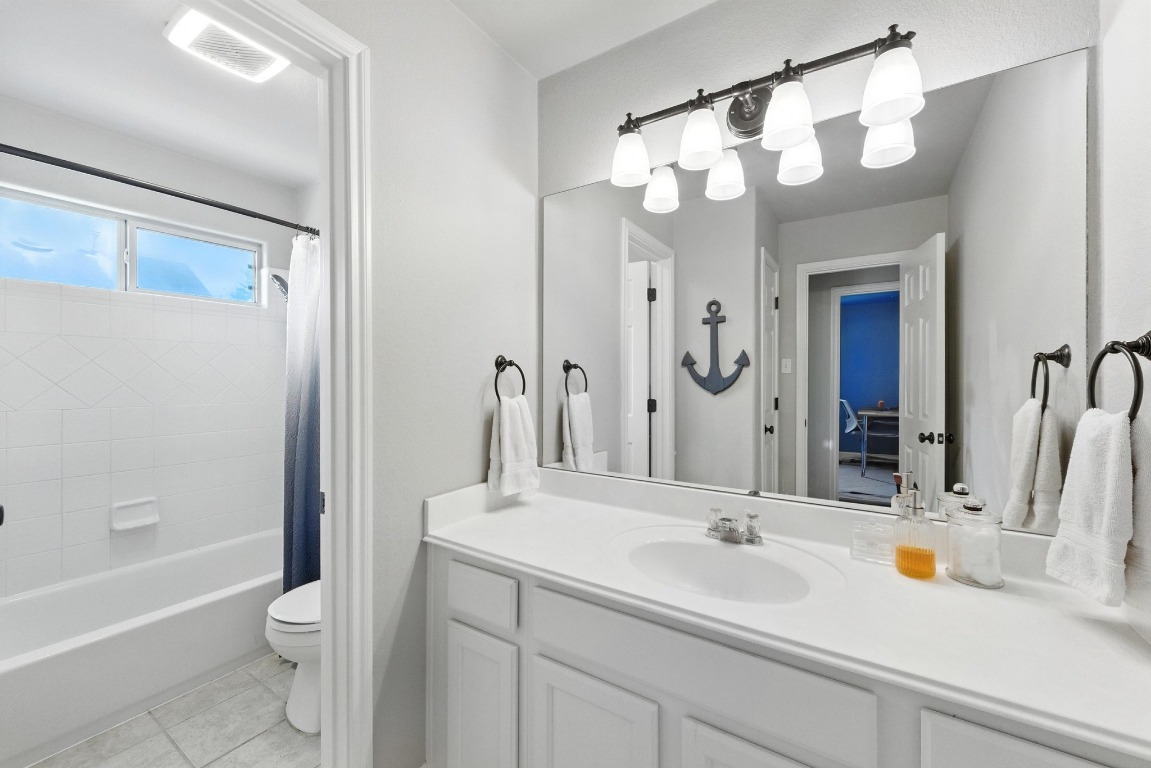 316 Caraway Kyle, TX 78640 - Photo 30 of 39 Bathroom with vanity, shower / bathtub combination with curtain, and tile patterned floors