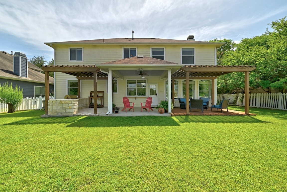 316 Caraway Kyle, TX 78640 - Photo 36 of 39 Back of property with a pergola, ceiling fan, a patio, and an outdoor hangout area