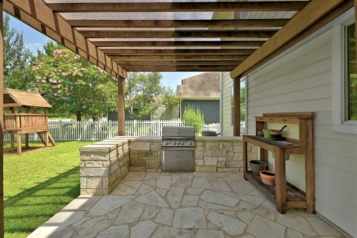 316 Caraway Kyle, TX 78640 - Photo 37 of 39 Fenced backyard with area for grilling, a patio, a playground, and a pergola