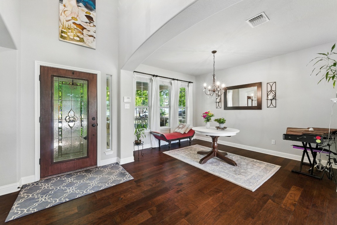 316 Caraway Kyle, TX 78640 - Photo 7 of 39 Entryway featuring high ceilings, wood floors, and a chandelier.