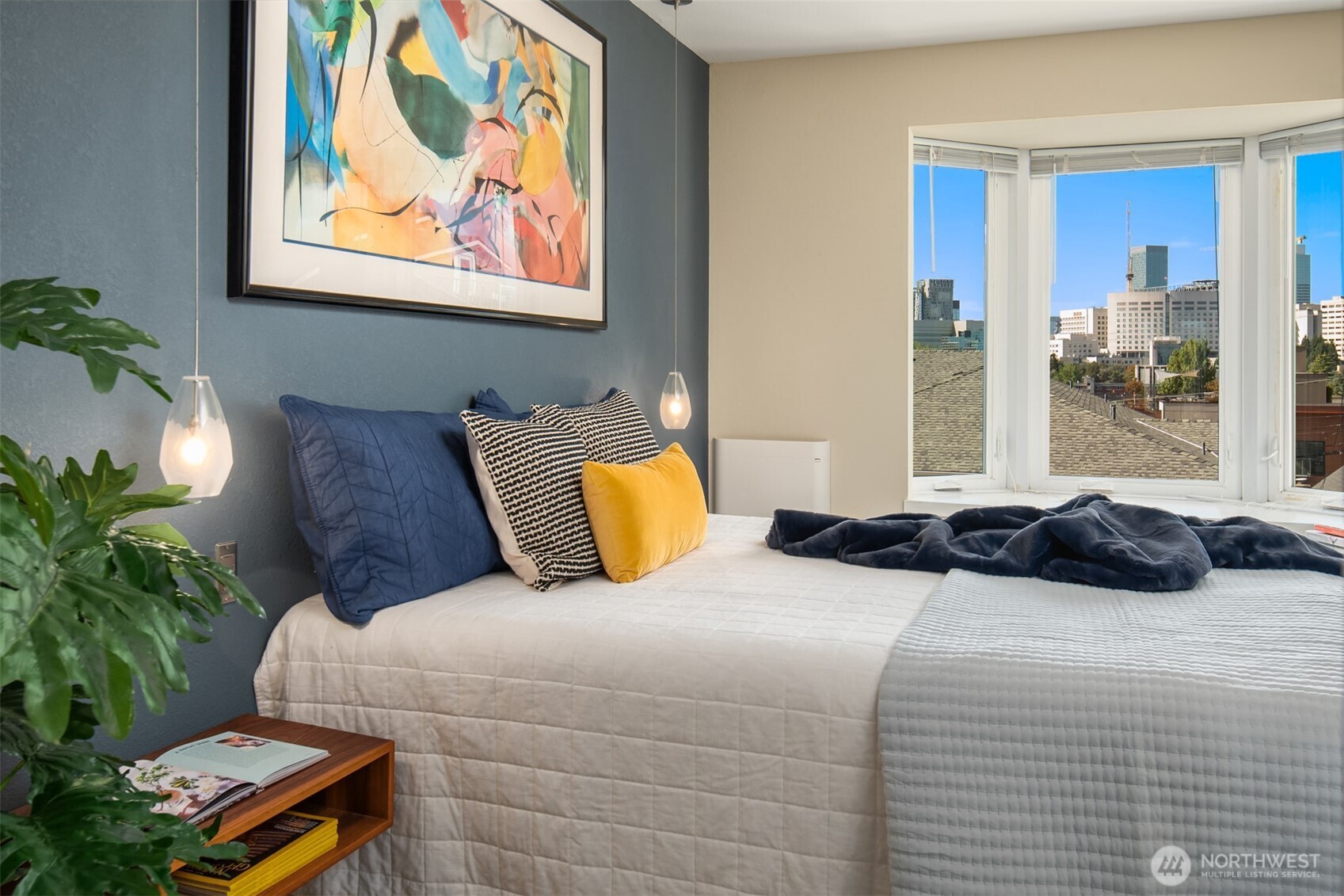 701 17th Avenue, Unit 305 Seattle, WA 98122 - Photo 19 of 36 a bedroom with a bed and a painting on the wall