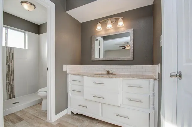 a bathroom with a sink vanity and a mirror