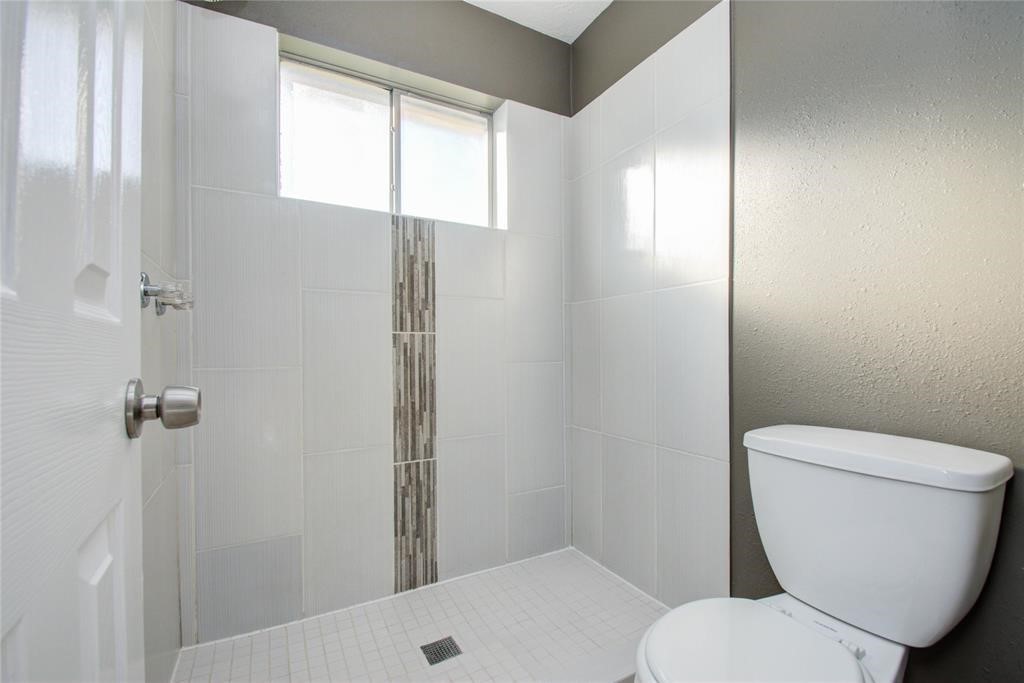 10510 Rancho Bernardo Lane Sugar Land, TX 77498 - Photo 15 of 27 a white toilet sitting next to a bathroom sink and tub