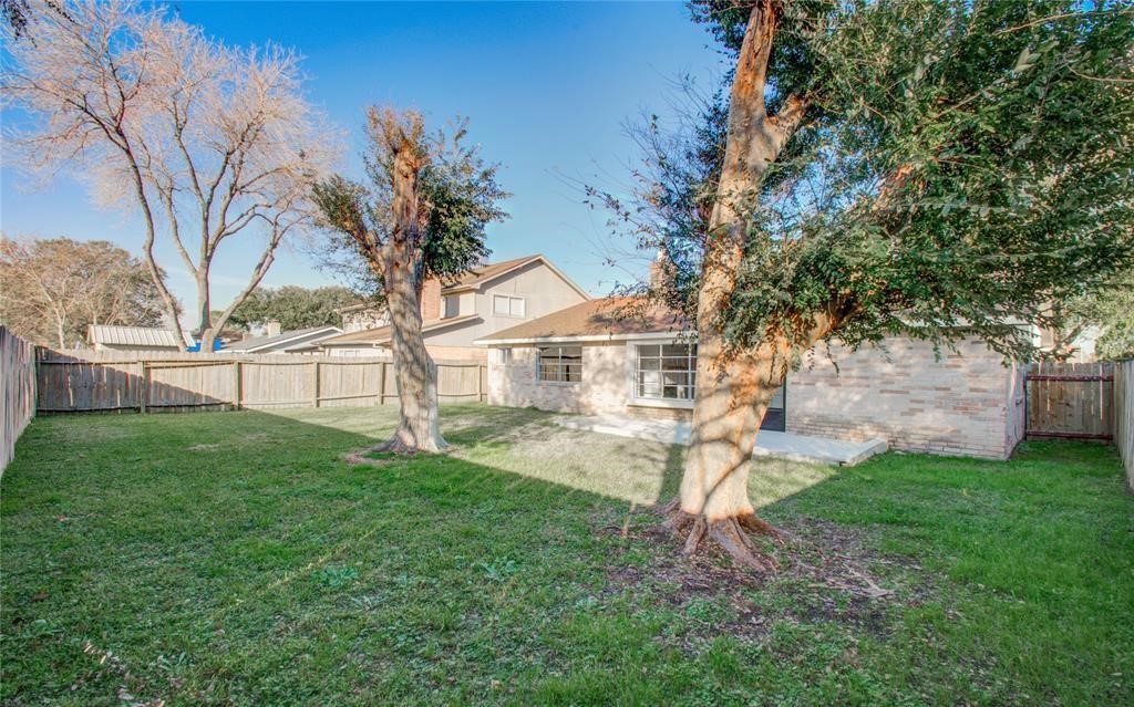 10510 Rancho Bernardo Lane Sugar Land, TX 77498 - Photo 27 of 27 a view of a backyard with a garden and trees