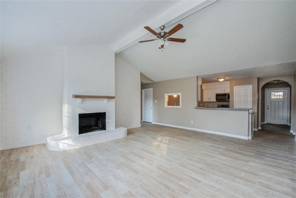 10510 Rancho Bernardo Lane Sugar Land, TX 77498 - Photo 7 of 27 a view of empty room with wooden floor and fireplace