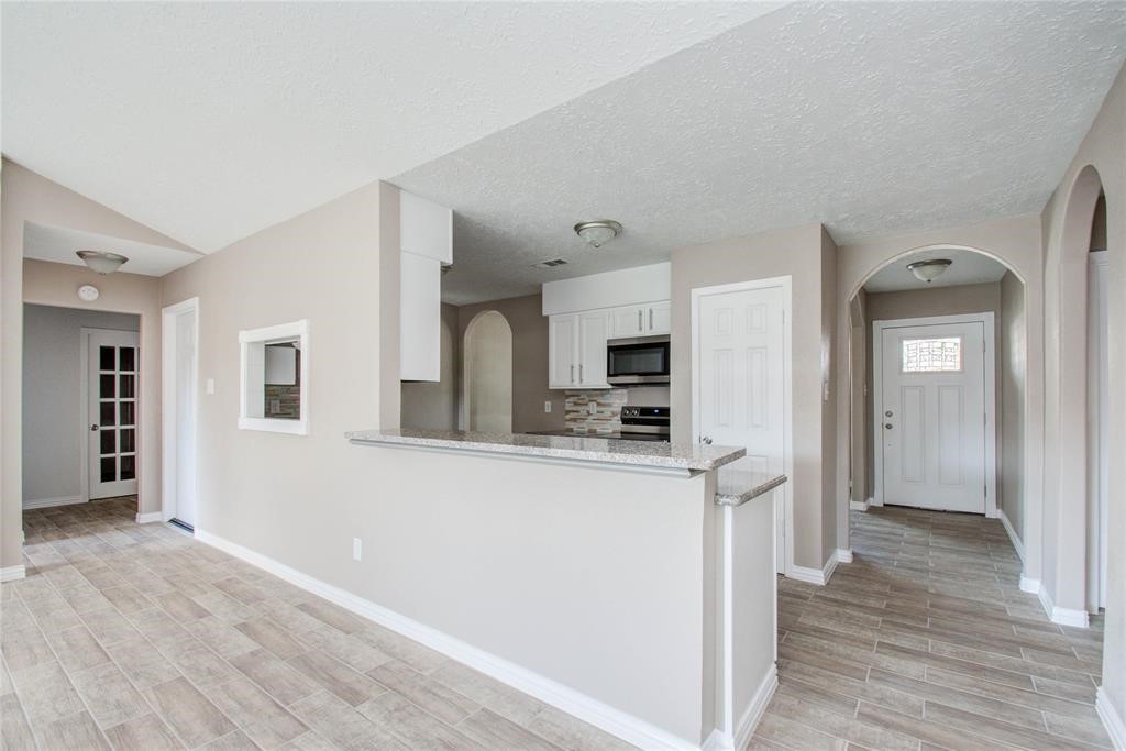 10510 Rancho Bernardo Lane Sugar Land, TX 77498 - Photo 8 of 27 a view of a kitchen with wooden floor and electronic appliances